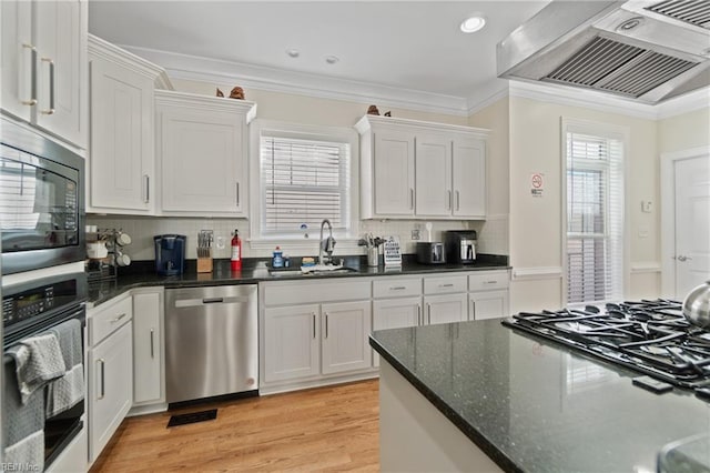 kitchen with crown molding, white cabinets, black appliances, and range hood