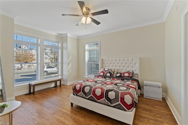 bedroom featuring ceiling fan, ornamental molding, and hardwood / wood-style flooring