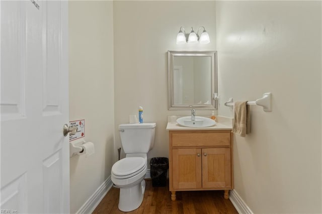 bathroom featuring vanity, toilet, and wood-type flooring