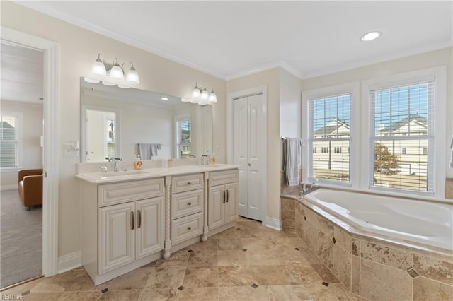 bathroom featuring vanity, ornamental molding, and tiled tub