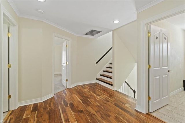 hall featuring light hardwood / wood-style floors and crown molding