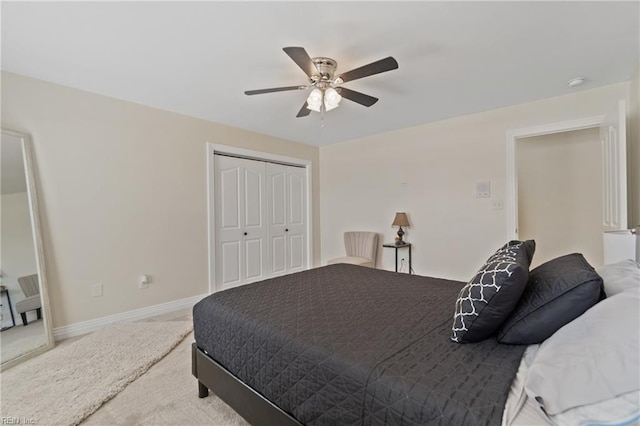 carpeted bedroom with a closet and ceiling fan