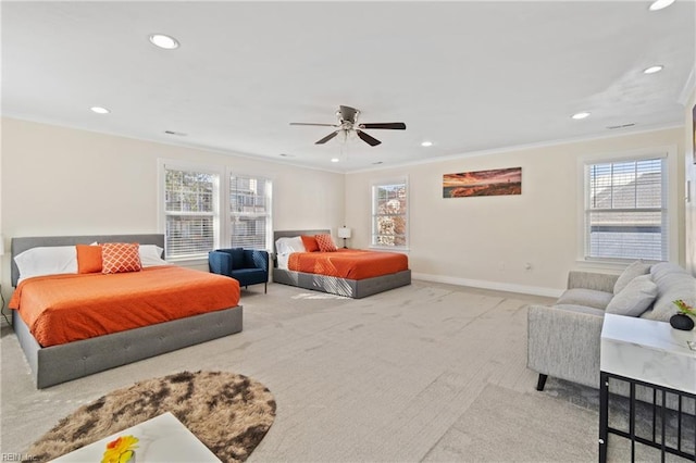 carpeted bedroom with multiple windows, ceiling fan, and ornamental molding