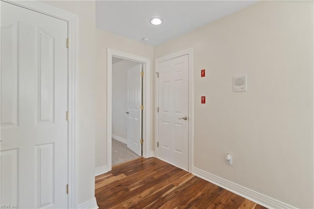 hallway with dark hardwood / wood-style flooring