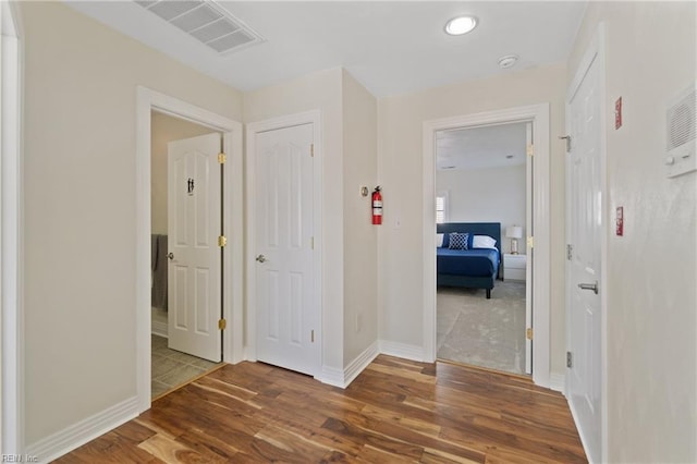 hall with wood-type flooring