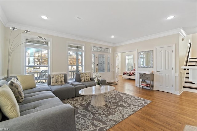 living room featuring hardwood / wood-style flooring and crown molding