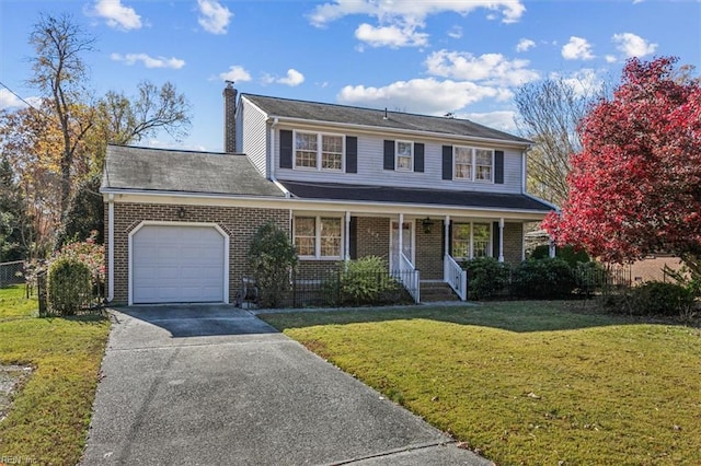 view of front property featuring a front yard, a porch, and a garage