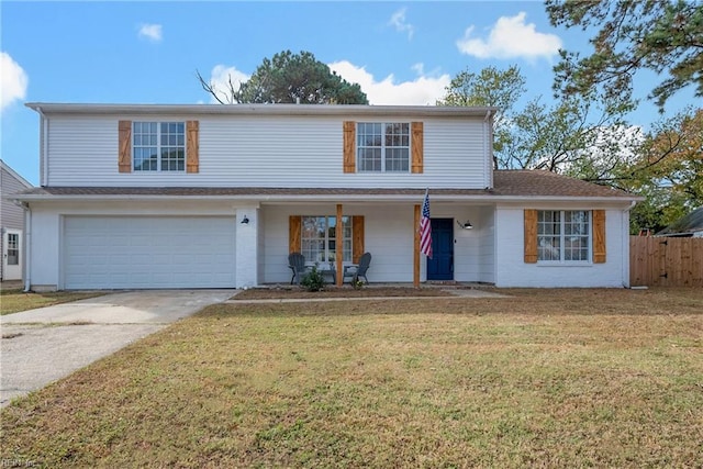 view of property featuring a front yard and a garage