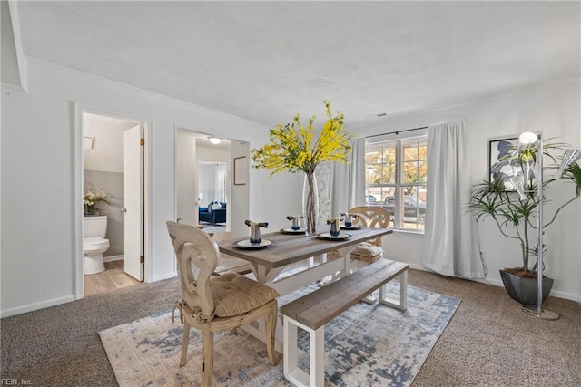 dining area with light colored carpet