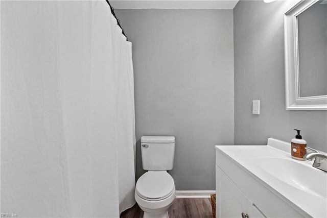 bathroom featuring vanity, toilet, and wood-type flooring