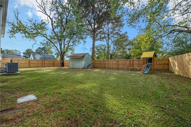 view of yard with a playground, central AC unit, and a storage unit