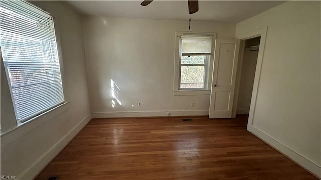 empty room featuring ceiling fan and dark hardwood / wood-style floors