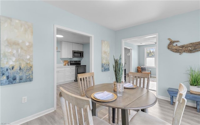 dining space featuring light wood-type flooring