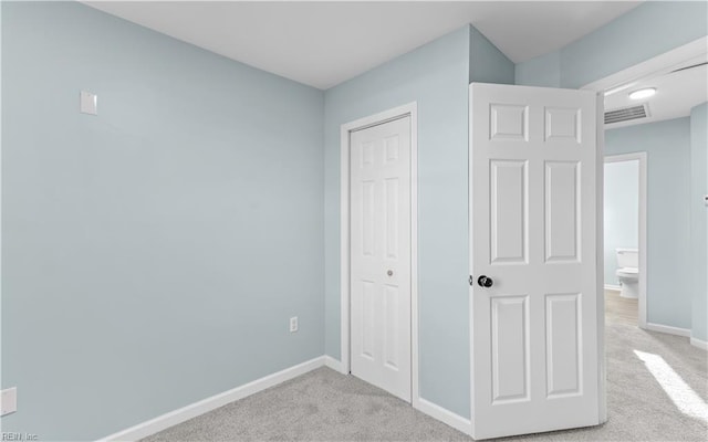 unfurnished bedroom featuring light colored carpet