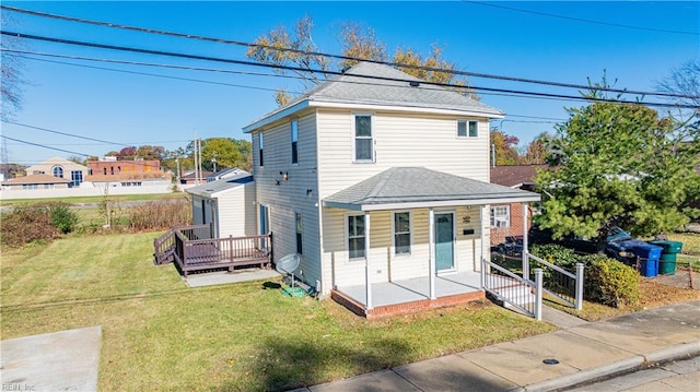 view of property featuring covered porch and a front lawn