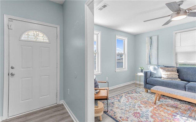 foyer with light hardwood / wood-style floors and ceiling fan