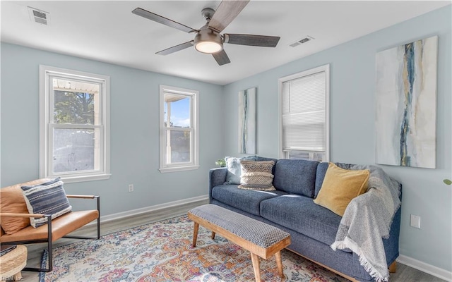 living room with hardwood / wood-style flooring, a wealth of natural light, and ceiling fan