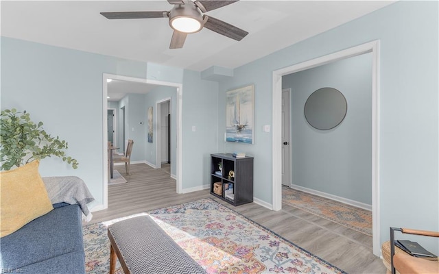 living room featuring ceiling fan and light wood-type flooring