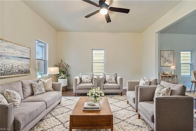 living room featuring ceiling fan, plenty of natural light, and light hardwood / wood-style floors