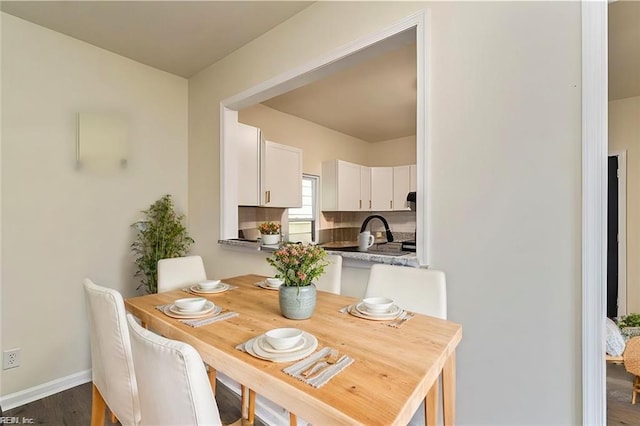 dining space with dark hardwood / wood-style floors