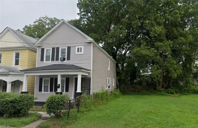 view of front facade with covered porch and a front lawn