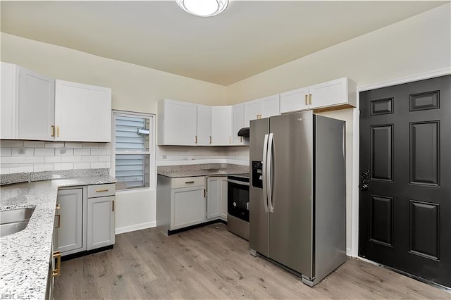 kitchen featuring white cabinetry, stainless steel appliances, and light wood-type flooring