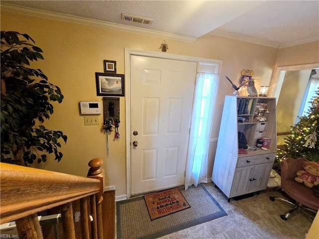 entryway with crown molding and plenty of natural light