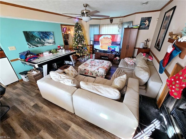 living room with wood-type flooring, a textured ceiling, ceiling fan, and crown molding