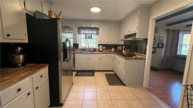 kitchen with plenty of natural light, light wood-type flooring, and white cabinetry