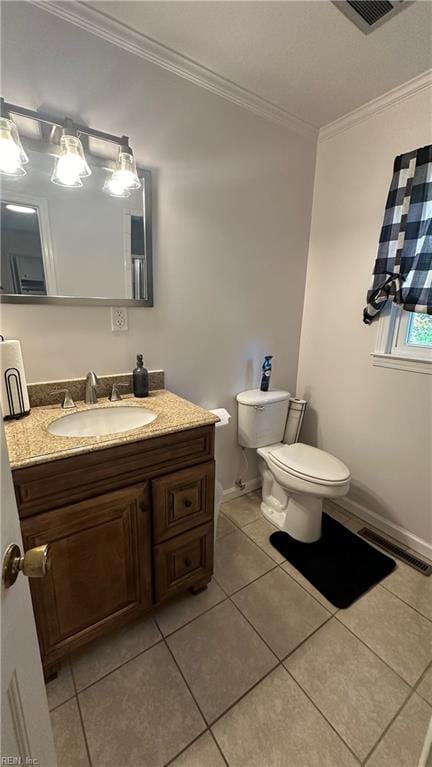 bathroom with crown molding, tile patterned flooring, and toilet