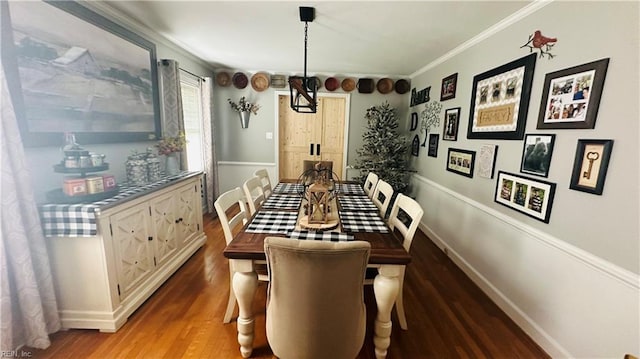 dining space featuring crown molding and dark hardwood / wood-style floors