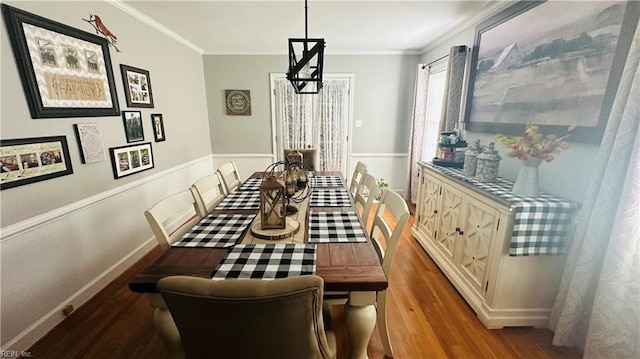 dining space featuring hardwood / wood-style floors and ornamental molding