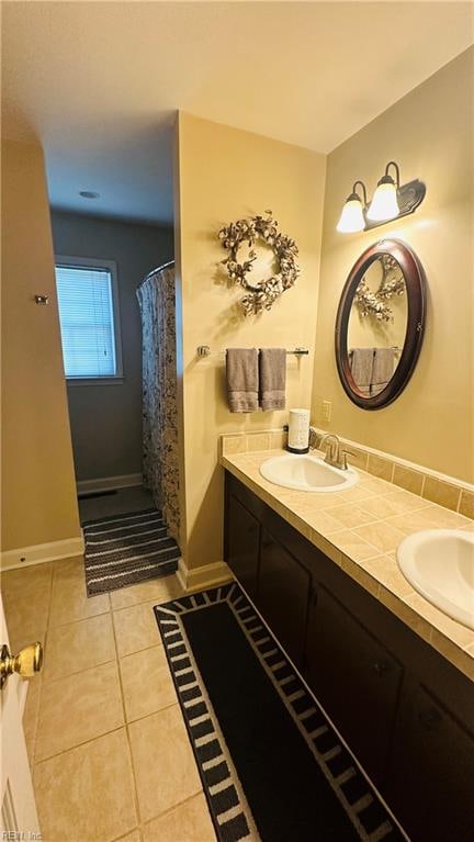 bathroom with curtained shower, tile patterned flooring, and vanity