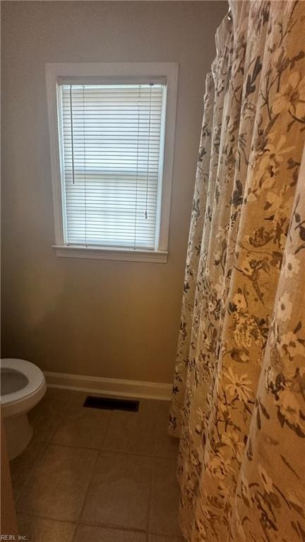 bathroom featuring tile patterned flooring and toilet