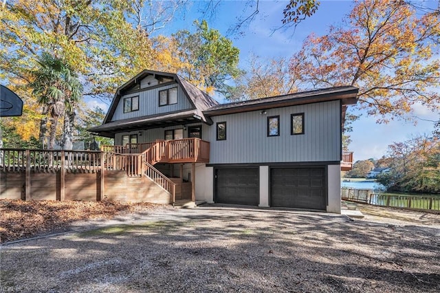 view of front of house featuring a garage and a deck with water view