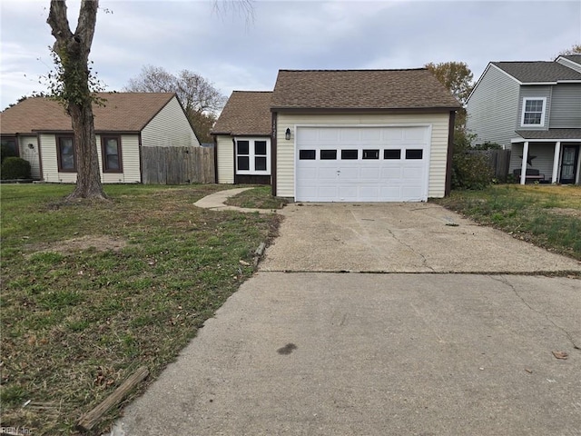 view of front of house featuring a front lawn and a garage