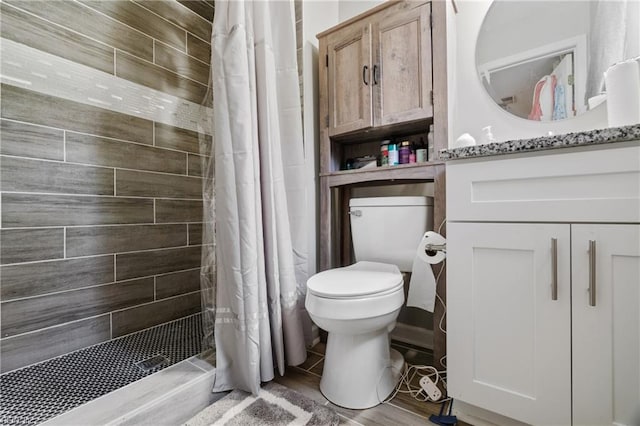 bathroom featuring hardwood / wood-style floors, curtained shower, and toilet