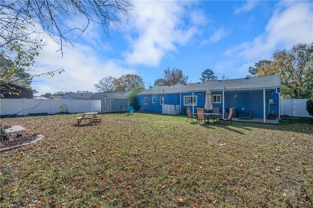 back of house featuring a yard and a patio area