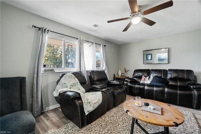 living room with light hardwood / wood-style floors and ceiling fan