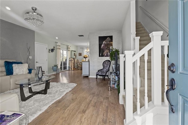 entryway featuring wood-type flooring and an inviting chandelier