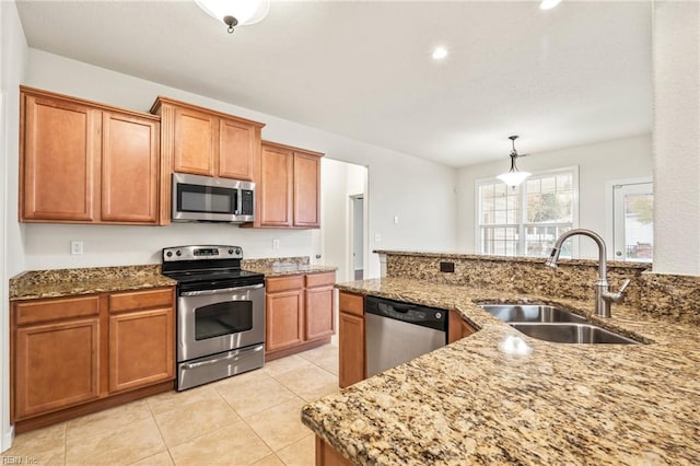 kitchen featuring sink, appliances with stainless steel finishes, decorative light fixtures, light tile patterned flooring, and light stone counters