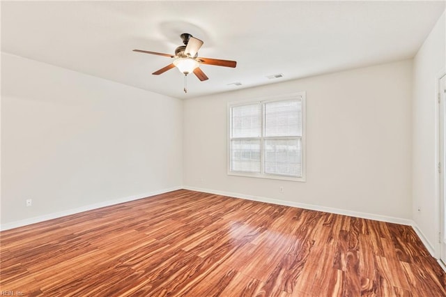 unfurnished room with hardwood / wood-style floors and ceiling fan