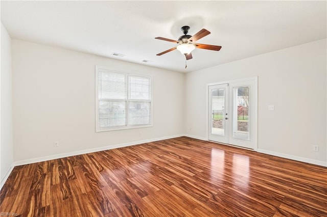 unfurnished room featuring hardwood / wood-style floors, french doors, and plenty of natural light