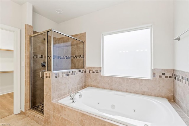 bathroom featuring shower with separate bathtub