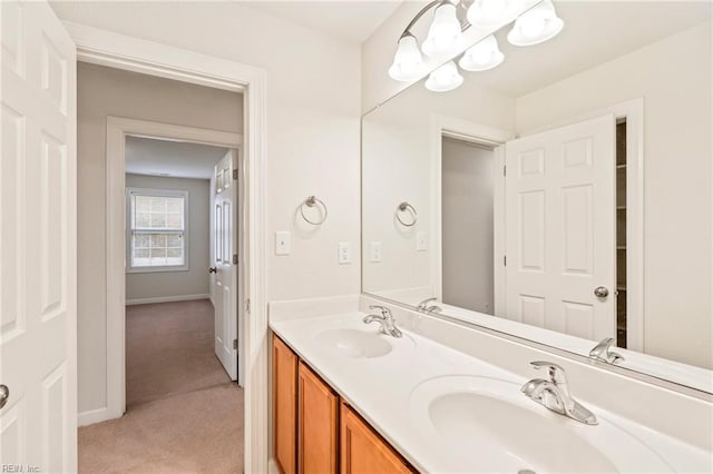 bathroom with vanity and a chandelier