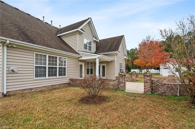 view of side of property with a patio area and a yard