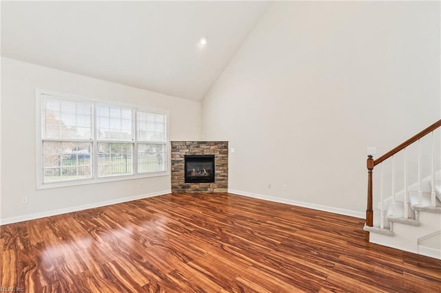 unfurnished living room featuring a fireplace, high vaulted ceiling, and dark wood-type flooring