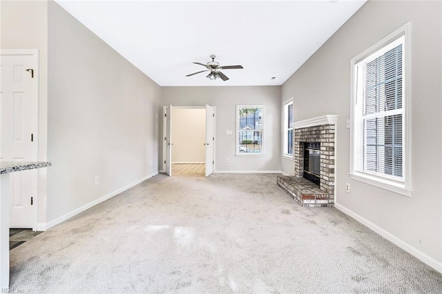 unfurnished living room featuring carpet flooring, ceiling fan, and a fireplace