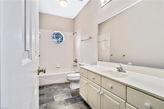 full bathroom featuring toilet, vanity, and tiled shower / bath