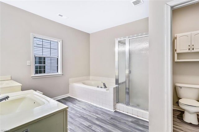 full bathroom featuring toilet, vanity, and hardwood / wood-style flooring